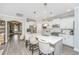 Modern kitchen with white cabinets, stainless steel appliances, an island with bar stools, and an open layout at 159 Garden Gate Way, Summerville, SC 29486