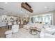 Bright open-concept living space with modern lighting, white sofas and seamless flow to kitchen and dining areas at 159 Garden Gate Way, Summerville, SC 29486
