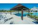 Inviting pool with a jacuzzi and a pergola, surrounded by lounge chairs and palm trees at 159 Garden Gate Way, Summerville, SC 29486