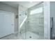 Bright bathroom featuring a glass shower with gray textured tiling and light neutral walls at 159 Garden Gate Way, Summerville, SC 29486