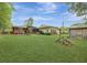 Expansive backyard with a deck, green lawn, and mature landscaping at 1636 Pinopolis Rd, Moncks Corner, SC 29461
