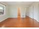 View of the bright bedroom showcasing hardwood floors and access to additional rooms at 1636 Pinopolis Rd, Moncks Corner, SC 29461