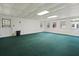Large, finished bonus room featuring green carpet, bright lighting, and a door to the exterior at 1636 Pinopolis Rd, Moncks Corner, SC 29461