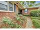 Charming brick home with manicured landscaping and a welcoming front entrance with mature flower bushes at 1636 Pinopolis Rd, Moncks Corner, SC 29461