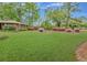 Charming brick home with lush green lawn and vibrant azalea bushes adding curb appeal at 1636 Pinopolis Rd, Moncks Corner, SC 29461