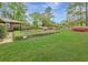 Well-manicured front yard with trimmed hedges and vibrant azaleas, enhancing the property's appeal at 1636 Pinopolis Rd, Moncks Corner, SC 29461