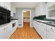 Efficient kitchen with white appliances and cabinets, open to the laundry area for convenience at 1636 Pinopolis Rd, Moncks Corner, SC 29461