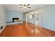 Bright living room with hardwood floors, brick fireplace, and open access to other living areas at 1636 Pinopolis Rd, Moncks Corner, SC 29461