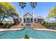 Beautiful backyard pool and patio with a water feature and two staircases leading up to the main house at 1644 Omni Blvd, Mount Pleasant, SC 29466