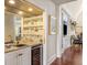 Entertainers wet bar with glass shelving and a wine fridge at 1644 Omni Blvd, Mount Pleasant, SC 29466