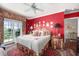 Comfortable bedroom with vibrant red walls, coordinated decor, and a view to the outside at 1644 Omni Blvd, Mount Pleasant, SC 29466