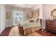Inviting bedroom featuring plush bedding, hardwood floors, and access to a private balcony at 1644 Omni Blvd, Mount Pleasant, SC 29466