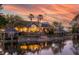 Stunning waterfront home at sunset, featuring a brick patio and lush landscaping at 1644 Omni Blvd, Mount Pleasant, SC 29466