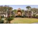 Elegant brick home with lush landscaping, palm trees, and a grand arched entrance at 1644 Omni Blvd, Mount Pleasant, SC 29466