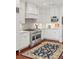 Chef's kitchen with custom cabinets, stainless steel appliances, and a marble backsplash at 1644 Omni Blvd, Mount Pleasant, SC 29466