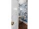 Charming powder room showcasing unique scenic wallpaper and a mirrored vanity at 1644 Omni Blvd, Mount Pleasant, SC 29466