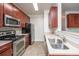 The kitchen has cherry wood cabinets, granite countertops, and stainless steel appliances at 1755 Central Park Rd # 3102, Charleston, SC 29412