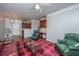 Cozy living room with a red plaid rug, comfortable seating, and a view into the kitchen at 1755 Central Park Rd # 3102, Charleston, SC 29412