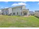 Spacious backyard with a well-maintained lawn, patio area, and a view of neighboring houses at 189 Weeping Cypress Dr, Moncks Corner, SC 29461