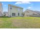Spacious backyard showcasing the home's exterior, lawn, and landscaping at 189 Weeping Cypress Dr, Moncks Corner, SC 29461