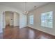 Bright dining room featuring hardwood floors, chandelier lighting, and large windows for natural light at 189 Weeping Cypress Dr, Moncks Corner, SC 29461