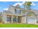 Charming two-story home with green siding, white trim, and a well-manicured front lawn at 189 Weeping Cypress Dr, Moncks Corner, SC 29461
