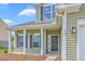 View of the front porch, showing hanging plants, and the address number next to the exterior light at 189 Weeping Cypress Dr, Moncks Corner, SC 29461
