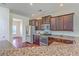 Kitchen features granite countertops, stainless steel appliances, and dark wood cabinetry for a modern touch at 189 Weeping Cypress Dr, Moncks Corner, SC 29461