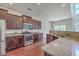 Well-equipped kitchen boasts stainless steel appliances, granite countertops, dark cabinetry and a sink overlooking the yard at 189 Weeping Cypress Dr, Moncks Corner, SC 29461