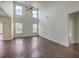 Spacious living room with hardwood floors, a high ceiling, and abundant natural light from large windows at 189 Weeping Cypress Dr, Moncks Corner, SC 29461