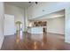 Open-concept living room features hardwood floors, high ceilings and seamless transition to kitchen with breakfast bar at 189 Weeping Cypress Dr, Moncks Corner, SC 29461
