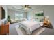 Relaxing main bedroom features a ceiling fan, plush carpet, accent chairs, and plenty of natural light at 189 Weeping Cypress Dr, Moncks Corner, SC 29461