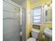 A full bathroom featuring a shower, sink, toilet, window, and towel hook at 1908 Palmetto Boulevard Blvd, Edisto Island, SC 29438