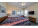 Bedroom featuring a bed with patterned bedding, TV, and sunny windows at 1908 Palmetto Boulevard Blvd, Edisto Island, SC 29438