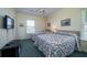 Bedroom with two twin beds, a TV, and bright, natural light at 1908 Palmetto Boulevard Blvd, Edisto Island, SC 29438
