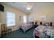 Cozy bedroom featuring two twin beds, a ceiling fan, and large windows for natural light at 1908 Palmetto Boulevard Blvd, Edisto Island, SC 29438