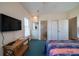 Bedroom has TV, closet, ensuite bathroom and light filled window at 1908 Palmetto Boulevard Blvd, Edisto Island, SC 29438