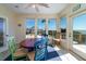 Bright sunroom with a dining table and ocean views, creating a relaxing atmosphere for meals at 1908 Palmetto Boulevard Blvd, Edisto Island, SC 29438