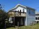 Coastal home featuring a spacious deck with seating, offering stunning views of the surrounding landscape at 1908 Palmetto Boulevard Blvd, Edisto Island, SC 29438