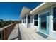 View of deck and ocean from charming home featuring a blue door, and wood railing at 1908 Palmetto Boulevard Blvd, Edisto Island, SC 29438