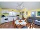 Bright kitchen with a wooden table with chairs and a gray sofa at 1908 Palmetto Boulevard Blvd, Edisto Island, SC 29438