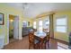 Open kitchen and dining area with a gray sofa and access to the outdoor deck at 1908 Palmetto Boulevard Blvd, Edisto Island, SC 29438