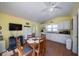 Cozy kitchen with wood floors, cottage cabinets, and a wooden table with seating for four at 1908 Palmetto Boulevard Blvd, Edisto Island, SC 29438