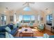 Spacious living room with large windows offering ocean views, hardwood floors, and comfortable seating at 1908 Palmetto Boulevard Blvd, Edisto Island, SC 29438