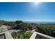 Stunning ocean view from a home's deck, showcasing the beach, lush greenery, and clear blue sky at 1908 Palmetto Boulevard Blvd, Edisto Island, SC 29438