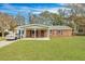 Charming brick home with a covered front porch and well-maintained lawn at 1932 Sunnyvale Ave, Charleston, SC 29414
