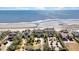 Stunning beachfront homes with manicured lawns and palm trees, offering direct access to the sandy shore at 212 Ocean Blvd, Isle of Palms, SC 29451