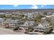 Aerial view showcasing homes with pools and beach access nestled among lush greenery at 212 Ocean Blvd, Isle of Palms, SC 29451