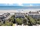 Aerial shot of a luxurious beachfront house with palm trees and easy beach access at 212 Ocean Blvd, Isle of Palms, SC 29451