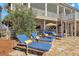 Backyard patio with comfortable lounge chairs and an umbrella, perfect for relaxing in the shade at 212 Ocean Blvd, Isle of Palms, SC 29451